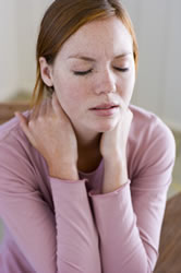 woman rubbing her neck and shoulders